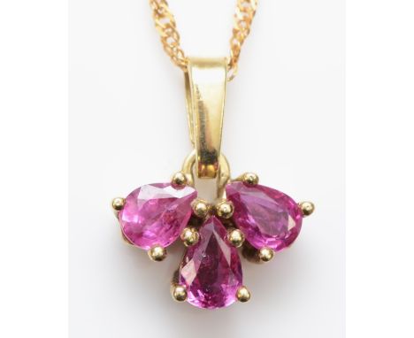 A 585 gold three stone pear cut ruby pendant, on 14k gold chain, 13mm, 2gm. 