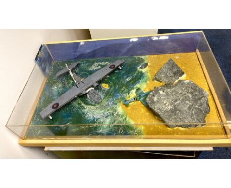 A perspex cased handmade model of a Catalina rescuing a pilot of a downed aircraft. Case size is 73cm x 44cm x 5cm.