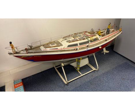 A large handmade working model of a racing yacht with stand, L. 142cm. (slight damage to hand rails). With cased sails.