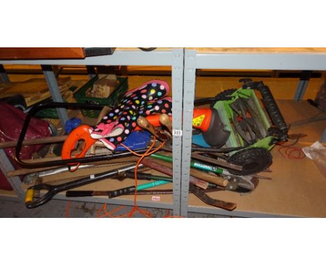 Large collection of gardening tools including strimmer