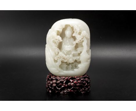 A WHITE JADE BOULDER CARVING Carved to one side with Guanyin within in a landscape with pine trees, the reverse with two figu