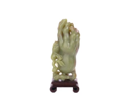 A CARVED JADE FINGER CITRON FORM VASE The stone carved in the form of a finger citron growing from a branch, a smaller fruit 