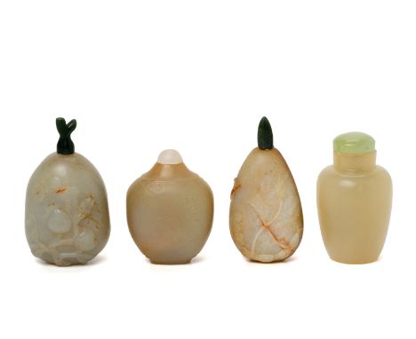A GROUP OF FOUR CARVED JADE SNUFF BOTTLES
Two of pebble from with shallow carved foliate decoration, one plain cylindrical ex