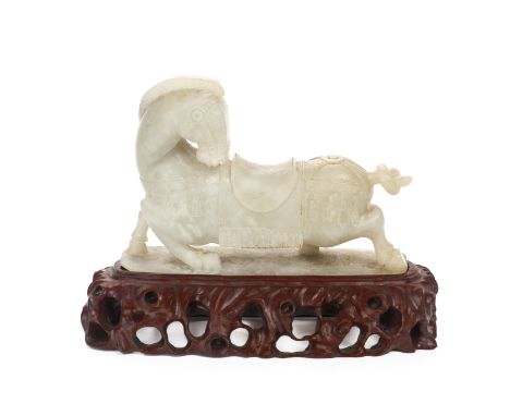 A JADE CARVING OF A HORSE
The stone of a white/grey mottled tone with darker grey inclusions, the horse modelled standing wit