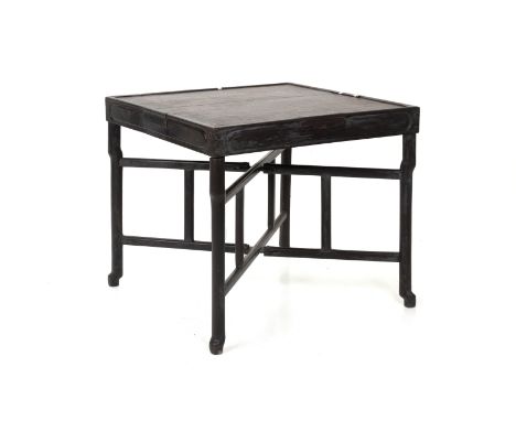 A BLACKWOOD MAHJONG TABLE The square top with raised edge and a small drawer to each side, raised on detachable folding suppo