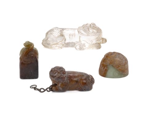 FOUR JADE AND ROCK CRYSTAL CARVINGS Comprising: a rock crystal mythical beast, in a recumbent position with its head turned; 