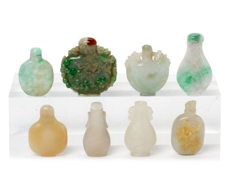 A GROUP OF EIGHT JADE AND HARDSTONE SNUFF BOTTLES
INcluding one carved with a rat amongst fruiting vines; a twin handled exam