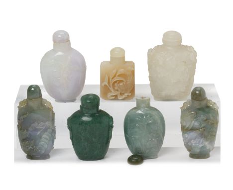 A GROUP OF SEVEN CARVED JADE SNUFF BOTTLES
Most with foliate carved decoration
*
Condition: For a condition report or further