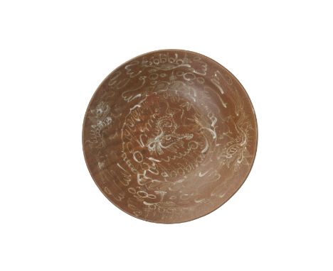 A 'HATCHER CARGO' BROWN GLAZED SLIP-DECORATED SWATOW DISH
Transitional period, mid-17th Century,
decorated with dragons and c