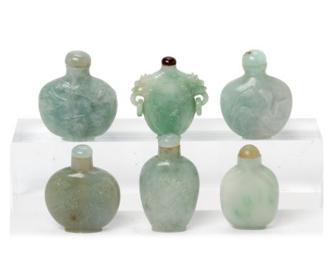 A GROUP OF SIX JADE SNUFF BOTTLES
Including one with twin dragon handles; others carved in shallow relief with foliage etc.
*