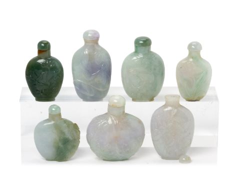 A GROUP OF SEVEN CARVED JADE SNUFF BOTTLES
Most with foliate carving in shallow relief, one with a goldfish amongst lotus, on