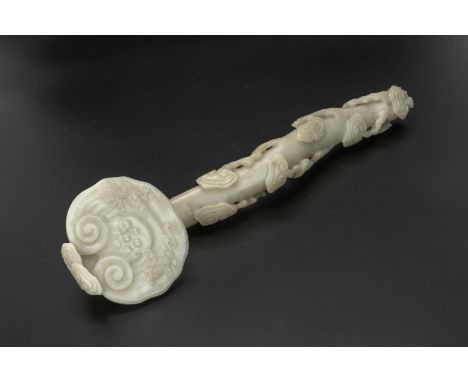 A CARVED JADE RUYI SCEPTRE
Of naturalistic form, the head carved with two immortal figures
42.5cm long
Condition: For a condi