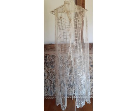 An early 20th Century cream wedding veil and an early 20th Century cream lace item of clothing later adapted to an overskirt 