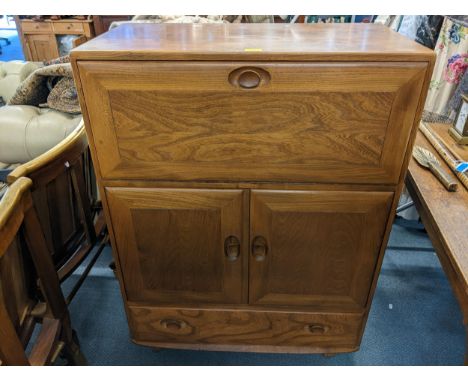 A mid 20th century retro Ercol Windsor bureau/drinks cabinet model 469 109cm h x 82.5cm w Location: 