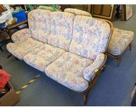 A retro Ercol three seater Jubilee sofa, two matching armchairs and footstoolsLocation: 