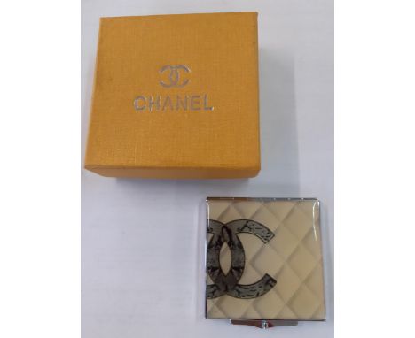 A vintage Chanel double mirror compact with iconic double CC logo on a white tone background, with branded box. Location:R1:3
