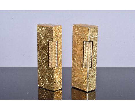 Two Dunhill gold plated lighters, both with similar engine turned design, both stamped US.RE24163, one with replacement white