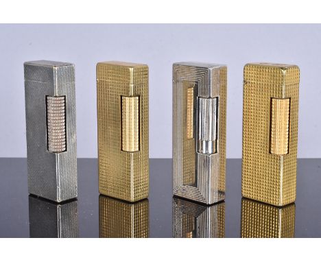 A group of four yellow and white metal Dunhill Rollagas pocket lighters, each with engine turned designs, two with missing fi