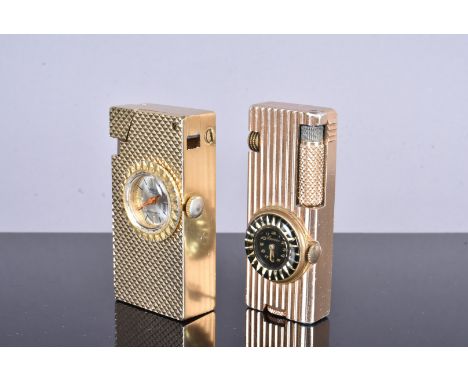 A Magy de Luxe yellow metal watch lighter, with diamond engine turned design, together with another yellow metal lighter (2),