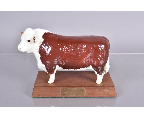 Hereford United Beswick China Bull, a Beswick China Bull on a wooden plinth with plaque engraved 'With the Compliments of Her