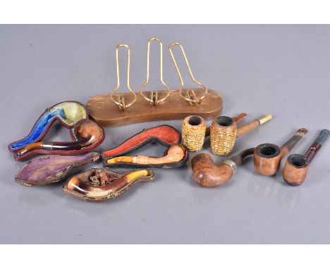An assortment of smoking pipes, including Meerschaums, Bern Wade, Petersons, two Cobb and a Falcon, plus a small three pipe s