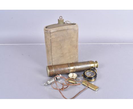 An assortment of military items, including two trench lighters, a 1935 military marked compass, an overseas compass, an ARP w
