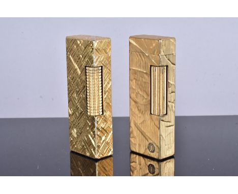 Two Dunhill gold plated lighters, both with AS Shield stamp, one with engine turned design, the other with a 'd' cartouche to