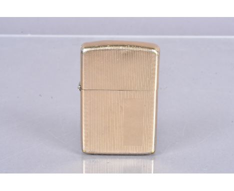 A 10K Filled Gold Zippo lighter, circa 1970s/1980s, with engine-turned design, minor damages, No postal shipment for this Lot