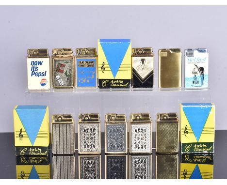 An assortment of Crown Musical pocket lighters, various designs, including Pepsi, Engraved, Engine Turned design and more, th