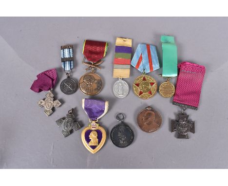 An assortment of military and other world medallions, including an Army Temperance Medal India, a copy of a Victorian Cross, 