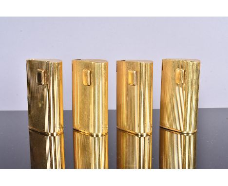 A group of four Ronson gold plated pocket lighters, each with the same vertical ribbed design, with PL of BAL stamp to the ba