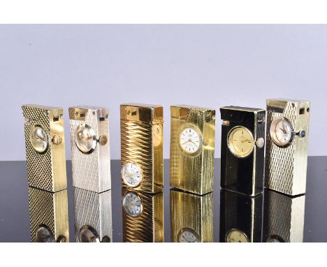 Six yellow metal watch lighters, comprising Bucherer, Hoba, Candy, Rivo, Foska and another, with engine turned and brushed de
