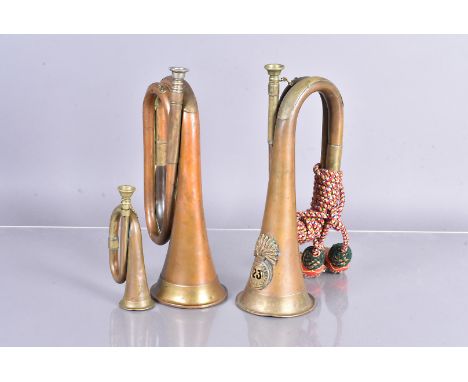 A 23rd Royal Welsh Fusiliers military bugle, complete with similar bugle without badge, plus a miniature example (3) 