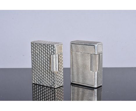 Two Dupont silver plated pocket lighters, one with serial 12FBK35, with geometric design, the other with serial 2656N, with p