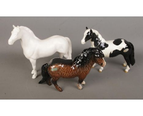 Three Beswick ceramic horses to include Palamino and Shetland examples. All with various repairs.  