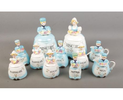 A collection of Dutch style ceramics of lidded boys/girls each being labelled a different food item including biscuits, jam, 