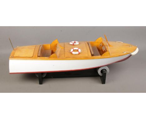 A remote control model pond cruiser titled Sea Hornet with display stand. Approx. boat length 65cm.  