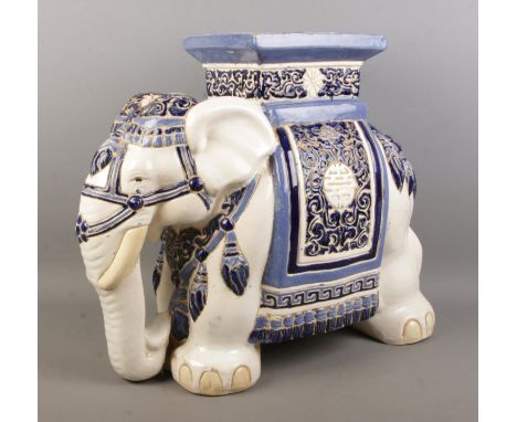 A large Oriental ceramic jardiniere formed as an elephant, decorated in blue and white. Length: 55cm, Width: 44cm.  