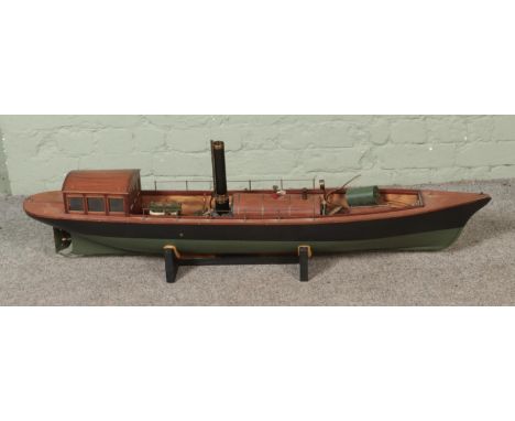 A large model Steamer boat fitted with horizontal boiler on display stand. Approx. length 130cm.  Steam boiler parts are loos
