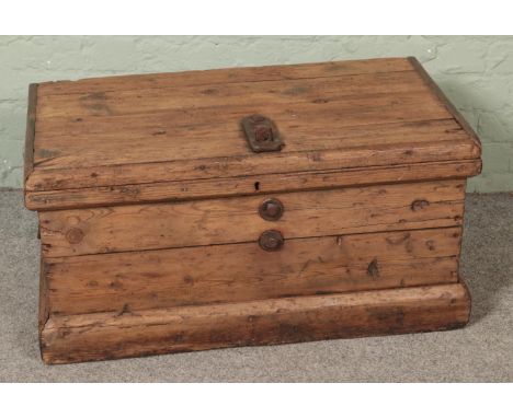 A rustic pine trunk with cast iron hasp lock lid  