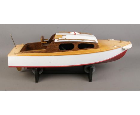 A motorised kit built model Sea Scout cabin cruiser boat on display stand. Approx. boat length 63cm.  