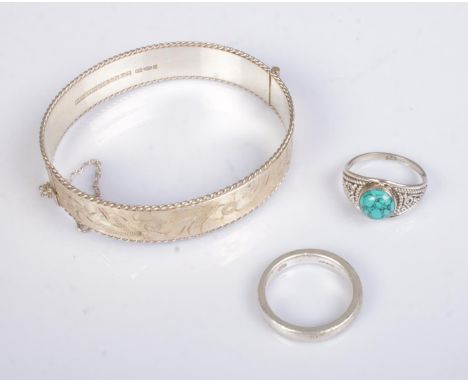 A small collection of silver jewellery to include floral engraved bangle and two rings. Total weight 29.8g.  
