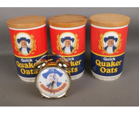 A collection of Quaker Oats collectables including three containers and an alarm clock  