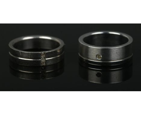 Two men's titanium rings set with clear paste stones. Sizes R and T.  