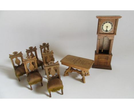 A pre-war dolls house suite comprising a Dutch style "X" framed table with printed "marquetry" top, 4 3/4" x 2 3/4", a set of