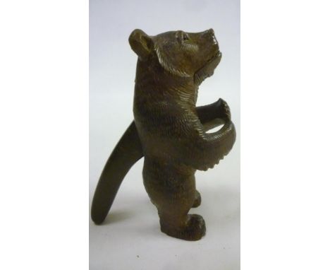 A Black Forest novelty carved treen standing bear nut-cracker, c.1920's, 7" high