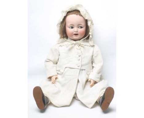 A large Kammer & Reinhardt bisque head toddler doll with blue glass flirty eyes, open mouth and teeth, brown mohair wig, join