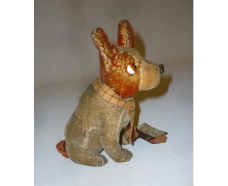 A Schuco seated dog, covered in red and beige plush, inset glass eyes, swivel head operated by tail, wool scarf, hanging pape