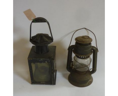 A B.R. railway lamp in japanned tin with oil burner and fixed handle, 13" high, and another oil lamp with burner and loop han