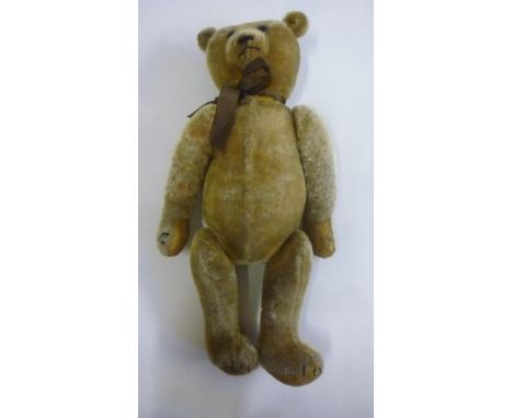 An American teddy bear, pre-war, straw filled, covered in golden plush, fully jointed with felt pads, button eyes, 20" high